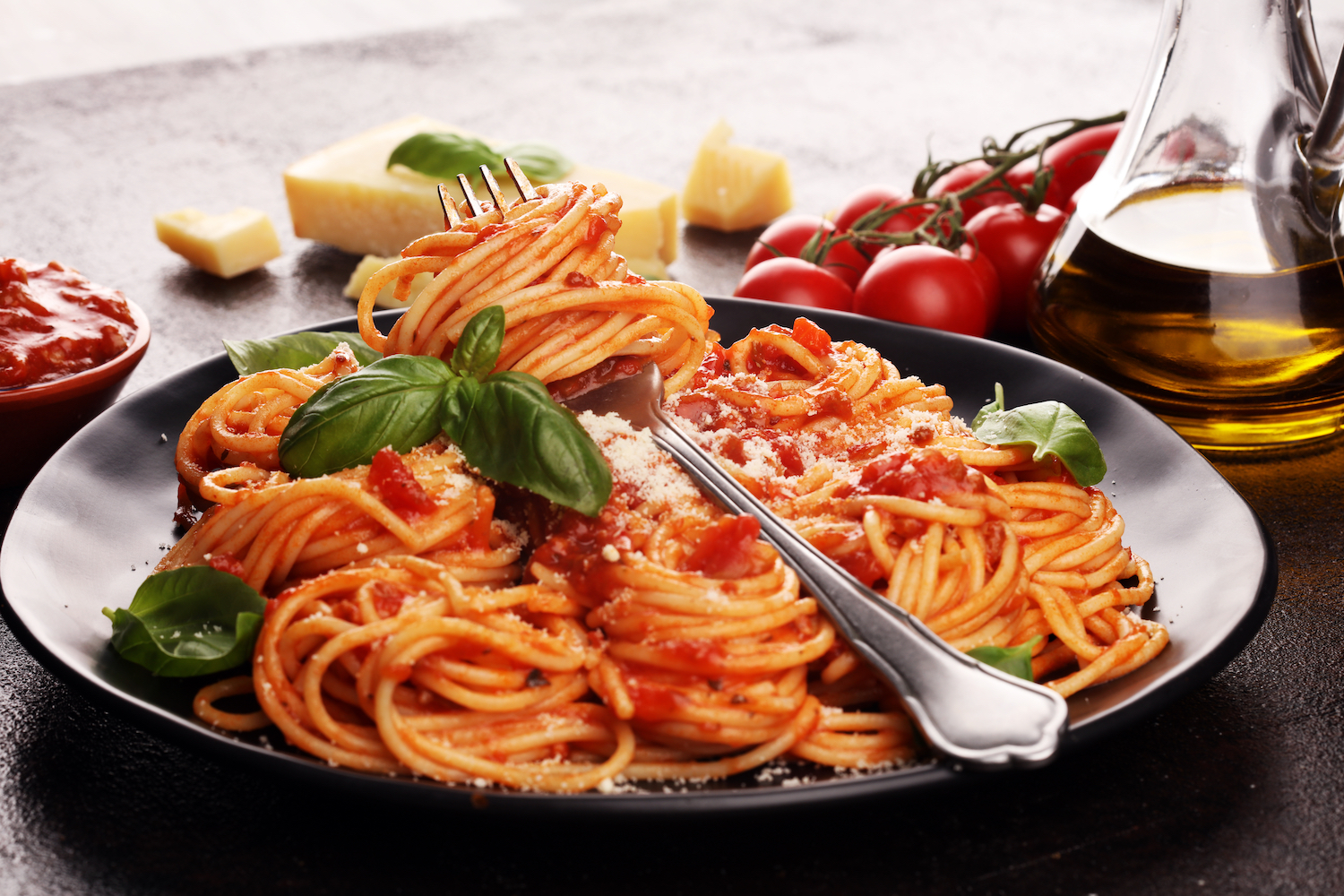 Plate of delicious spaghetti Bolognaise or Bolognese with savory minced beef and tomato sauce garnished with parmesan cheese